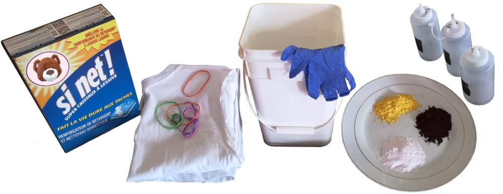 Tools and supplies for tie-dyeing, including soda ash, a shirt, elastic bands, dyes and dye bottles